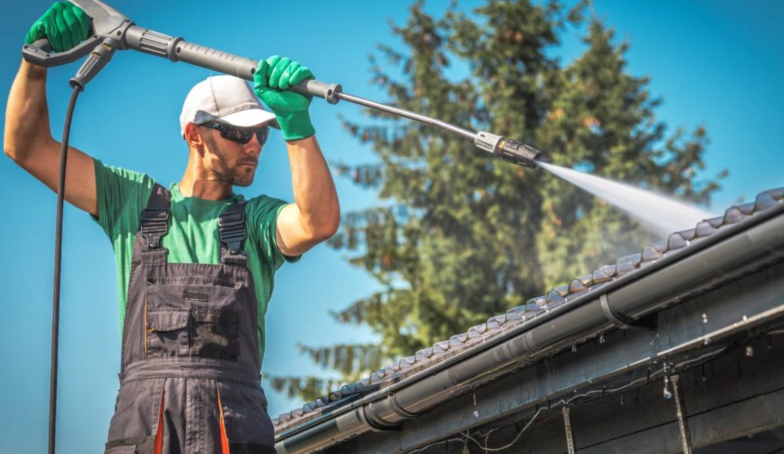 Washing Plastic Transparent Carport Roof by Caucasian Men. Pressure Washer Job.