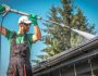 Washing Plastic Transparent Carport Roof by Caucasian Men. Pressure Washer Job.